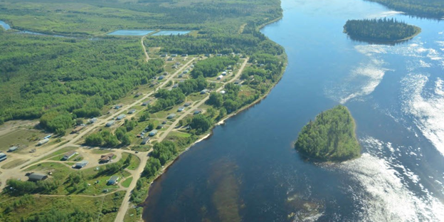 An aerial photo of Marten Falls First Nation and a river.